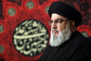 Hassan Nasrallah, red arabic background