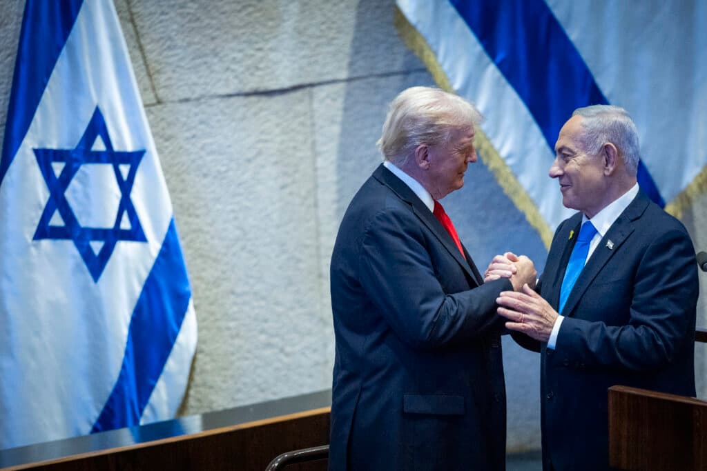 U.S. President Donald Trump and Israeli Prime Minister Benjamin Netanyahu shake hands at the Knesset in Jerusalem.