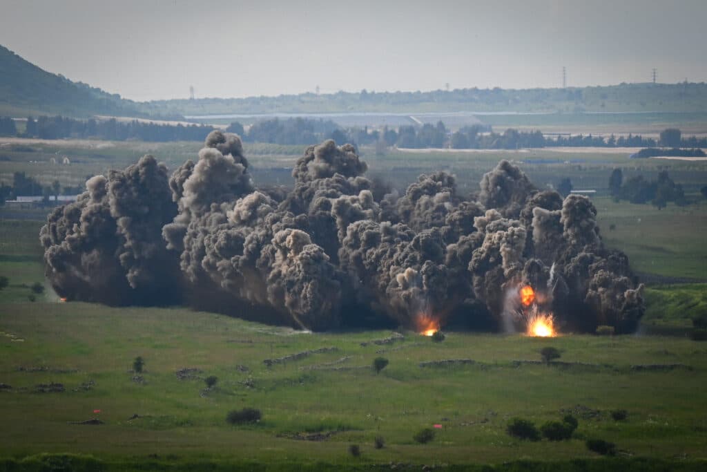 Smoke and fire rise from an explosion.