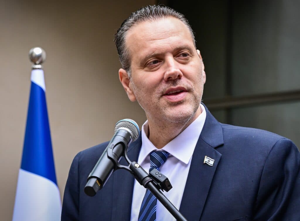 Minister Miki Zohar speaking into a microphone
