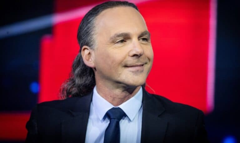 Dr. Avishai Ben Haim appears on a television set with a red background.