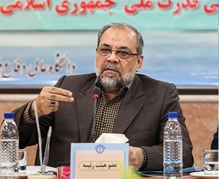 Mohammad Bagher Zolghadr speaking at a table during an official meeting.