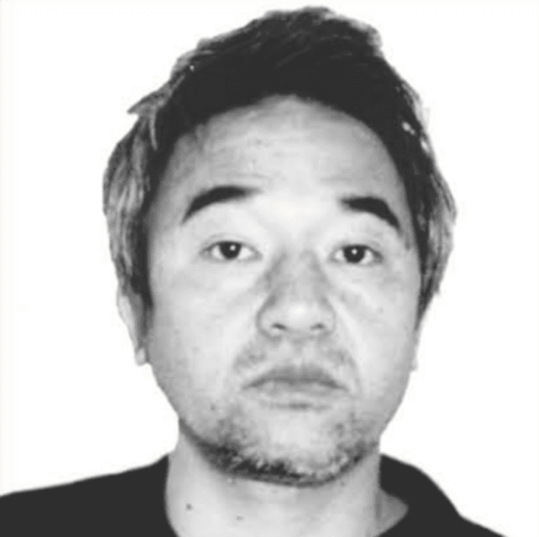 Black-and-white wanted photo of Kōzō Okamoto.