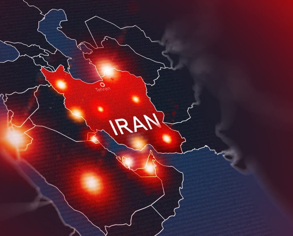 Map of Iran highlighted in red with glowing strike points across the region.