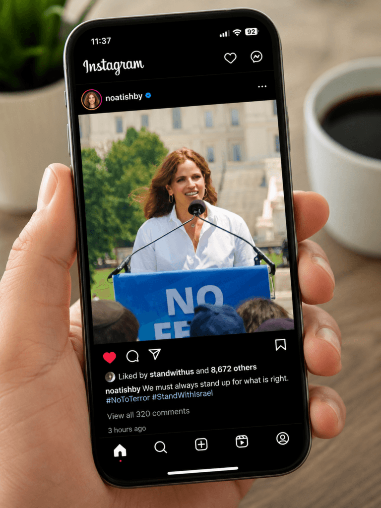 Noa Tishby at a Washington DC rally, on instagram on a smartphone in someone's hand.