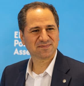 Samy Gemayel standing before a blue European People’s Party background.
