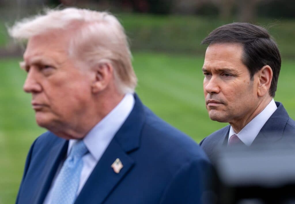 President Donald Trump stands near Secretary of State Marco Rubio outside the White House.
