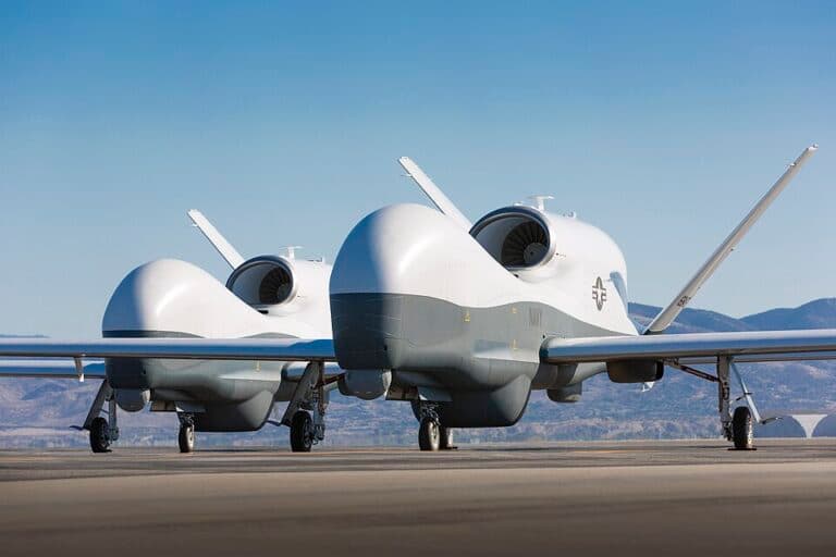 Two MQ-4C Triton unmanned aerial vehicles on a tarmac in Palmdale, California.