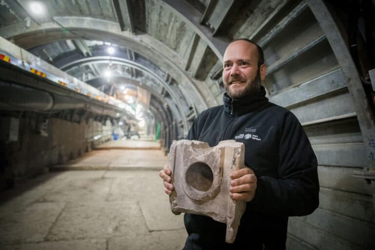 archaeologist ari levi holds artifact found in pilgrimage road excavation