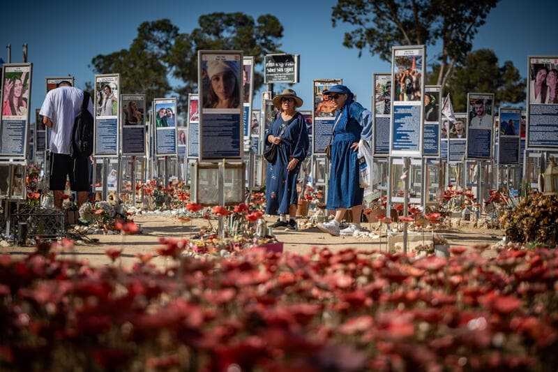 Visitors walk among memorials for victims of the Nova Music Festival massacre near Kibbutz Re’im.